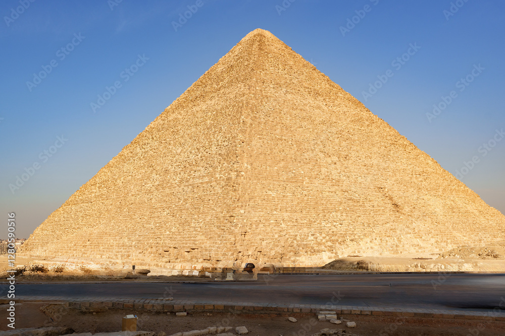 Majestic Great Pyramid standing tall under the clear blue sky in Giza, Egypt during late afternoon sunlight Majestic Great Pyramid standing tall under the clear blue sky in Giza, Egypt during late afternoon sunlight