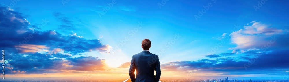 A person stands gazing at a vibrant sunrise, symbolizing hope and new beginnings against a backdrop of beautiful clouds. A person stands gazing at a vibrant sunrise, symbolizing hope and new beginnings against a backdrop of beautiful clouds.