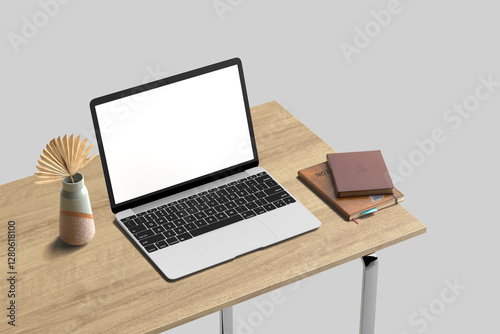Blank laptop screen on wood table with books