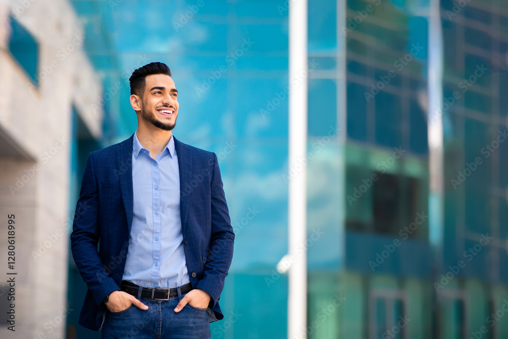 Handsome middle-eastern young businessman in stylish suit posing by office center, smiling arab entrepreneur having break after successful busienss meeting, standing on street, looking at copy space Handsome middle-eastern young businessman in stylish suit posing by office center, smiling arab entrepreneur having break after successful busienss meeting, standing on street, looking at copy space
