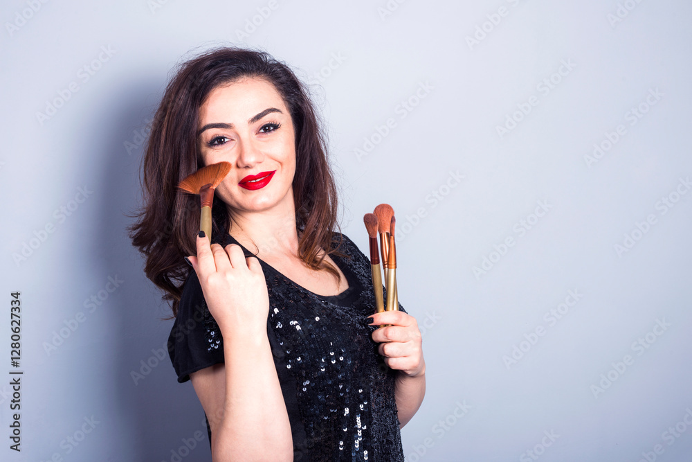 young model applying powder on her cheeks young model applying powder on her cheeks