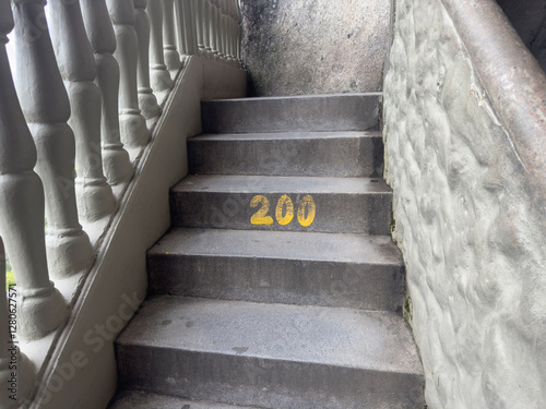 Stone staircase with '200' in yellow on the fourth step.