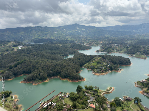 Scenic view of green hills and islands amidst a winding river under cloudy skies.