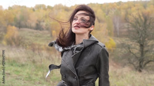 Girl in fall trench. Autumn landscape with gothic woman has windy hair. Stylish woman sing in autumn landscape outdoor. Fall nature landscape and girl. Central park in New York. Yellow fall