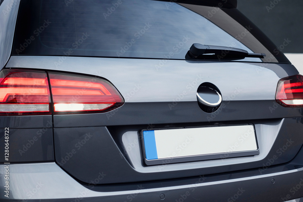 Modern compact dark gray car, with beautiful wheels, a large chrome radiator grill. Exterior details. Modern compact dark gray car, with beautiful wheels, a large chrome radiator grill. Exterior details.
