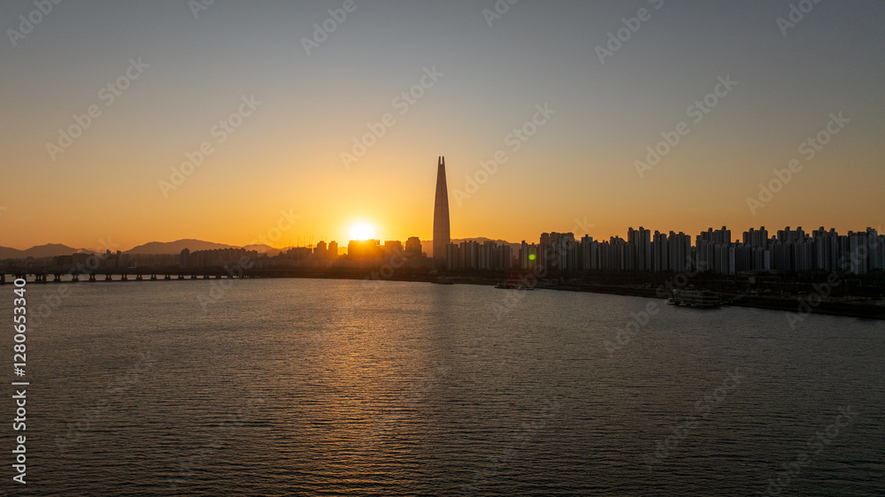 Naklejka premium Aerial view of Seoul, South Korea, with the Hangang River winding through the city, video by towering skyscrapers and historical landmarks 