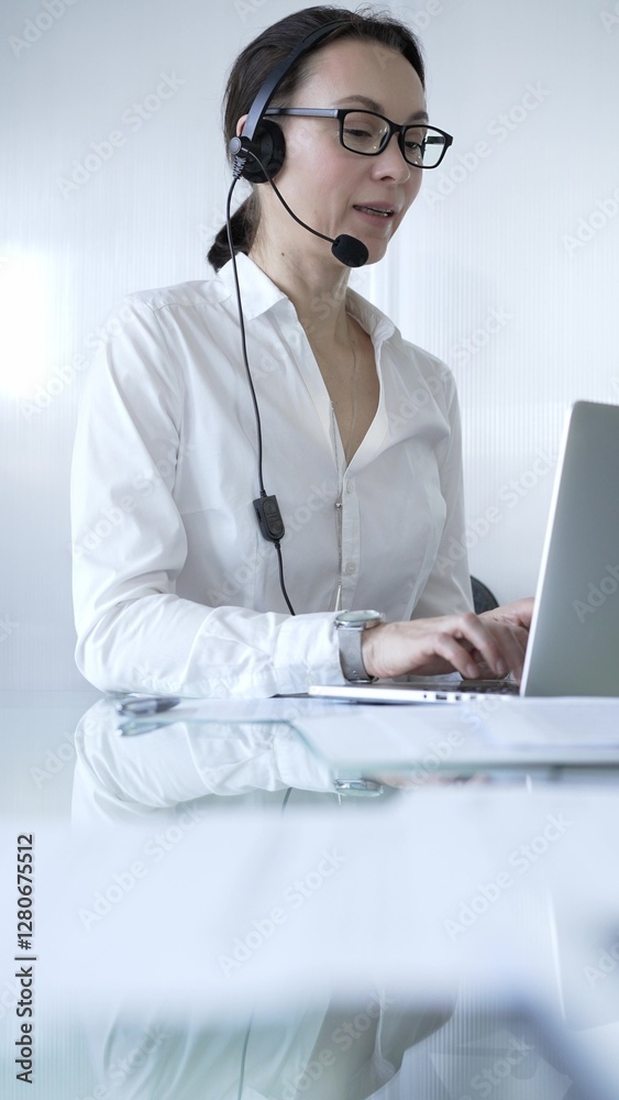 Female secretary wearing headset and working on laptop, providing customer support or online service. Business people concept Female secretary wearing headset and working on laptop, providing customer support or online service. Business people concept