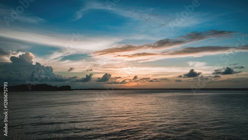 Wallpaper Mural Serene sunset panorama with blended blue and orange hues, lush clouds above calm water, capturing summer evening tranquility and beauty Torontodigital.ca