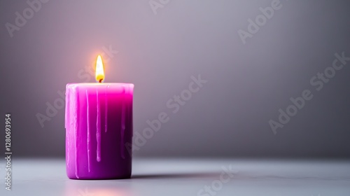 Violet candle with flame in serene setting.