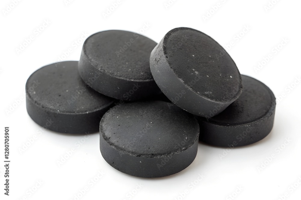 activated carbon tablets, black color isolated on white background activated carbon tablets, black color isolated on white background