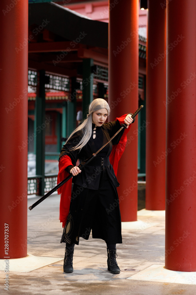 A warrior girl in a Chinese costume practices wushu kung fu with weapons in an open area. National martial art.