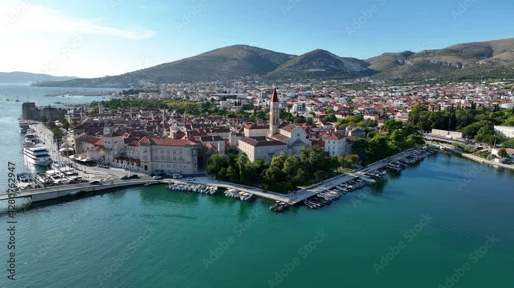 Aerial establishing overview of Trogir stunning coastal landscape, with boats in the harbor and historic town center on sunny day Aerial establishing overview of Trogir stunning coastal landscape, with boats in the harbor and historic town center on sunny day