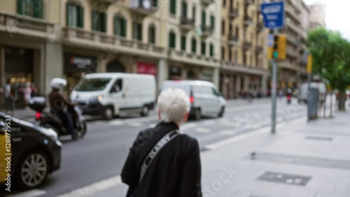 Wallpaper Mural Elderly woman on blurred barcelona street with buildings and traffic in the background. Torontodigital.ca