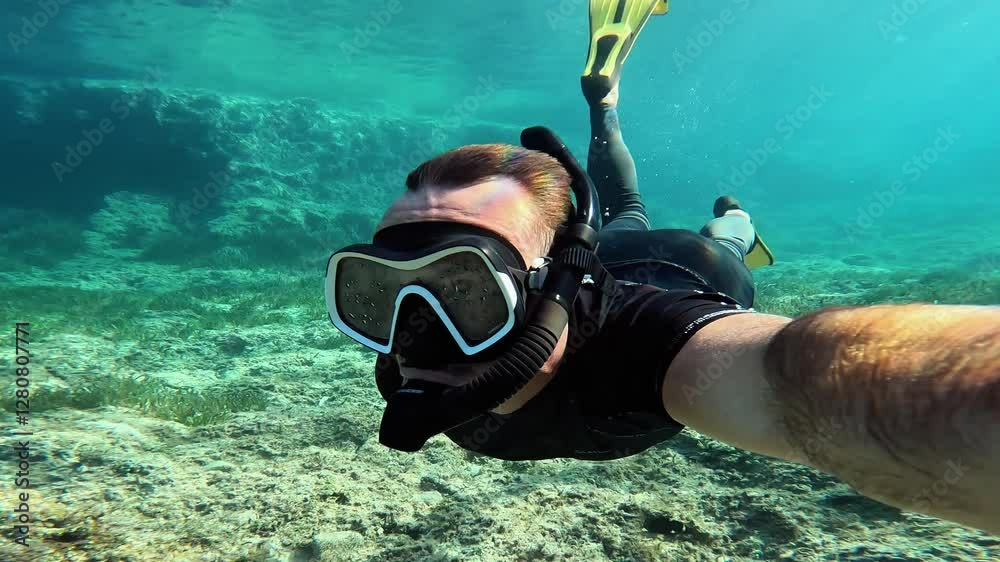 Lone man snorkeling in the turquoise waters of Ibiza, Balearic Islands