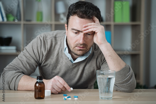 One man taking painkillers to relieve pain