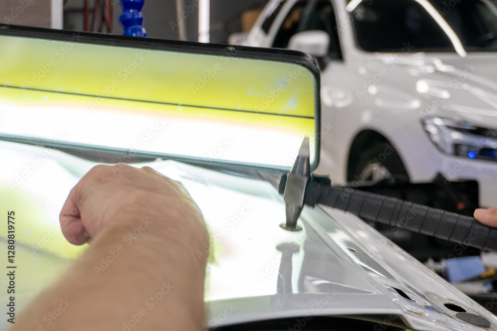 Removing dents on the car. PDR technology. Car body repair without painting. A specialist repairs a dent on the car body without painting. Body car repair. Removing dents on the car. PDR technology. Car body repair without painting. A specialist repairs a dent on the car body without painting. Body car repair.