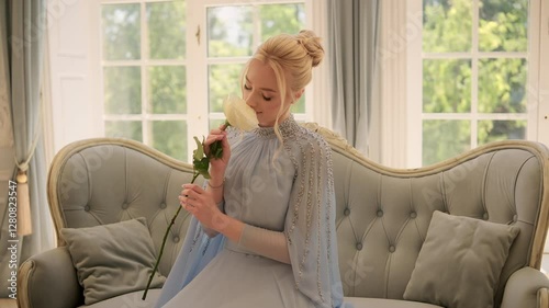 Sensual woman sits on a coach with a rose, romantic intimate atmosphere, emphasizing the woman's graceful demeanor. Intricate details on the dress, conveying serene charm. 4K High Quality