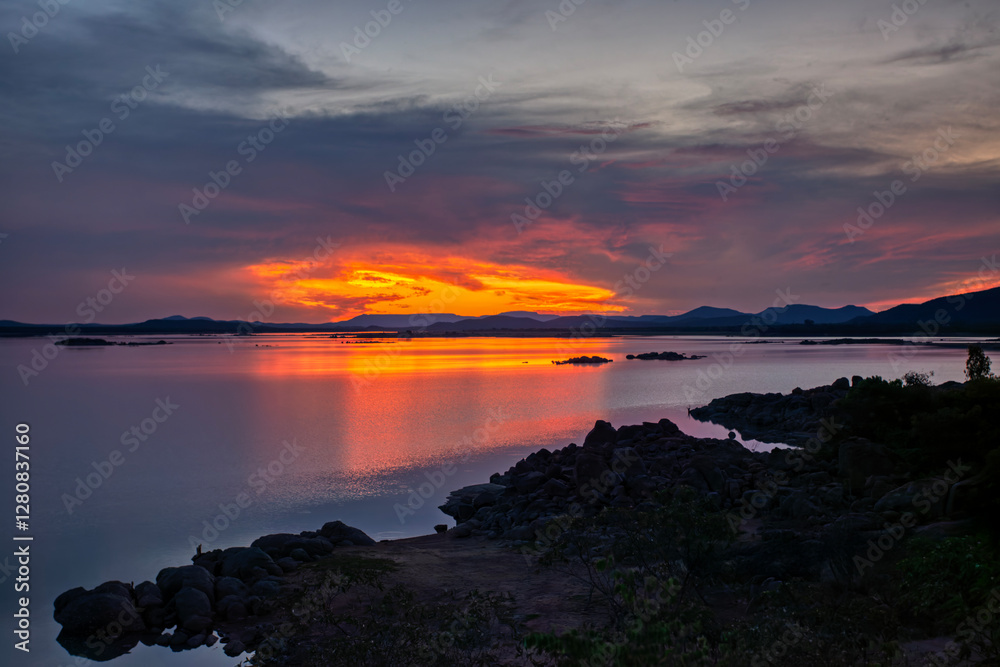 Gaborone dam in Botswana view at twilight, unspoiled nature , conservation area, teal and orange sky Gaborone dam in Botswana view at twilight, unspoiled nature , conservation area, teal and orange sky