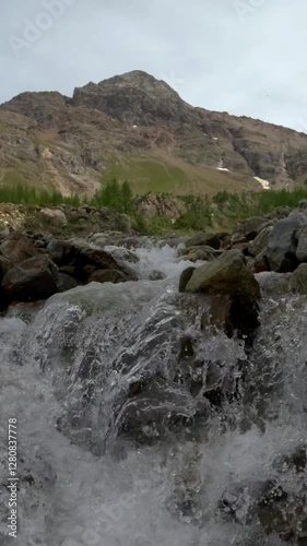 glacial water cascades within rocky alpine stream nature raw energy