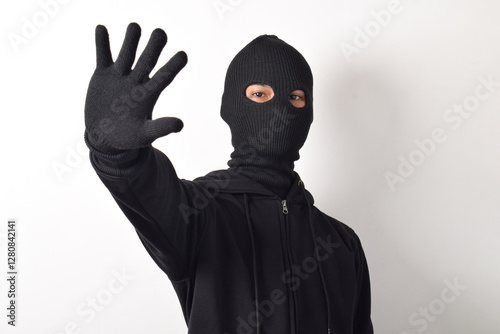 Foto Thief wearing black jacket and mask isolated on white background