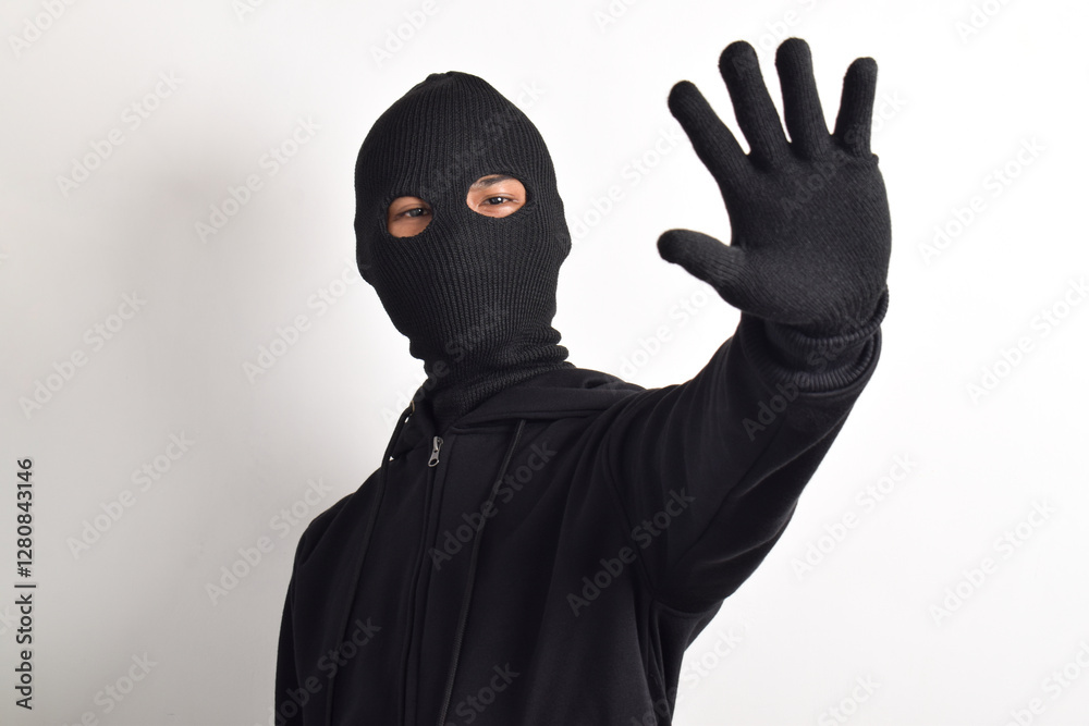Thief wearing black jacket and mask isolated on white background. Robbery and criminal concept Thief wearing black jacket and mask isolated on white background. Robbery and criminal concept