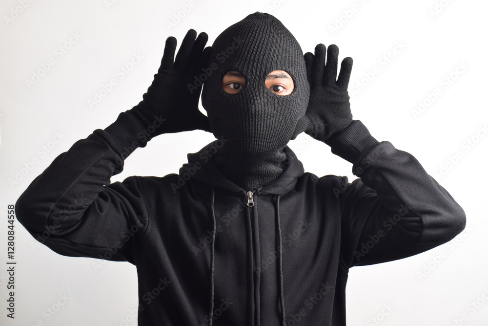 Thief wearing black jacket and mask isolated on white background. Robbery and criminal concept Thief wearing black jacket and mask isolated on white background. Robbery and criminal concept