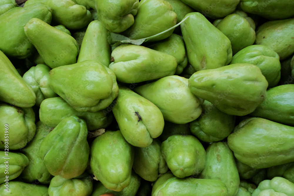 Fresh, ripe green chayote (Labu Siam) with smooth skin and firm texture, showcasing its natural freshness and vibrant color Fresh, ripe green chayote (Labu Siam) with smooth skin and firm texture, showcasing its natural freshness and vibrant color