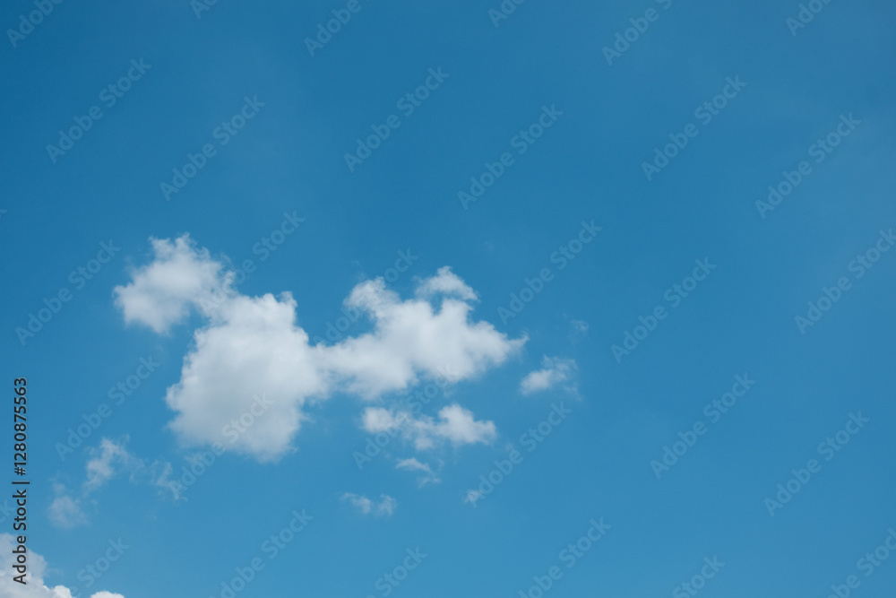 A simple, minimalistic scene of a lone white cloud floating in a vast blue sky, creating a clean and serene atmosphere A simple, minimalistic scene of a lone white cloud floating in a vast blue sky, creating a clean and serene atmosphere