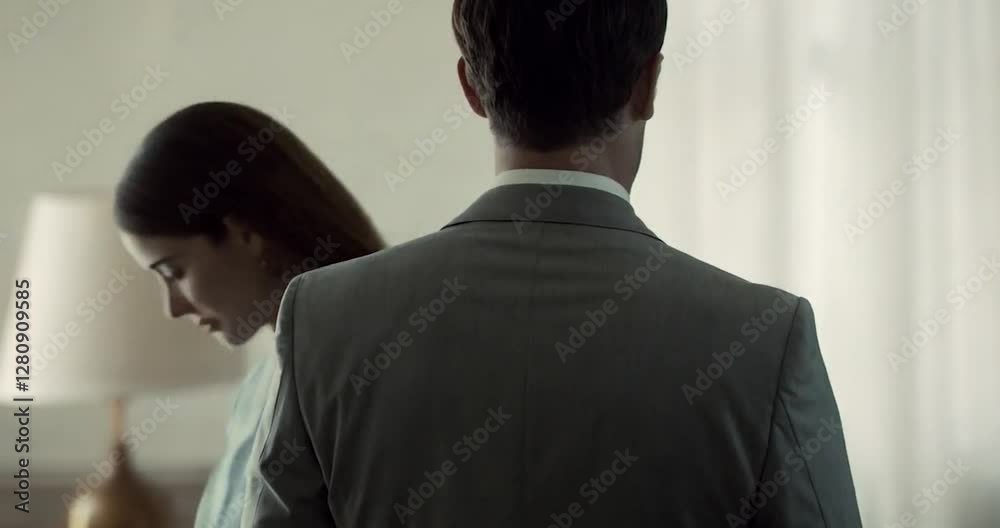 Couple Embracing Inside With Soft Lighting and Blue Dress And Grey Suit For A Man Couple Embracing Inside With Soft Lighting and Blue Dress And Grey Suit For A Man