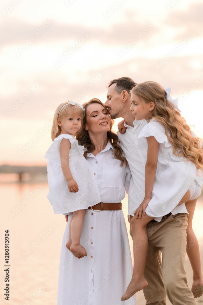 happy family with two children in white clothes walking on the river bank at sunset happy family with two children in white clothes walking on the river bank at sunset