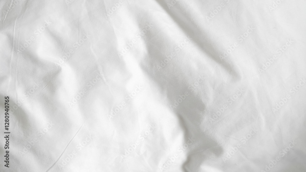Fototapeta premium White bedsheets with a smooth clean surface creating a calm and restful space.
