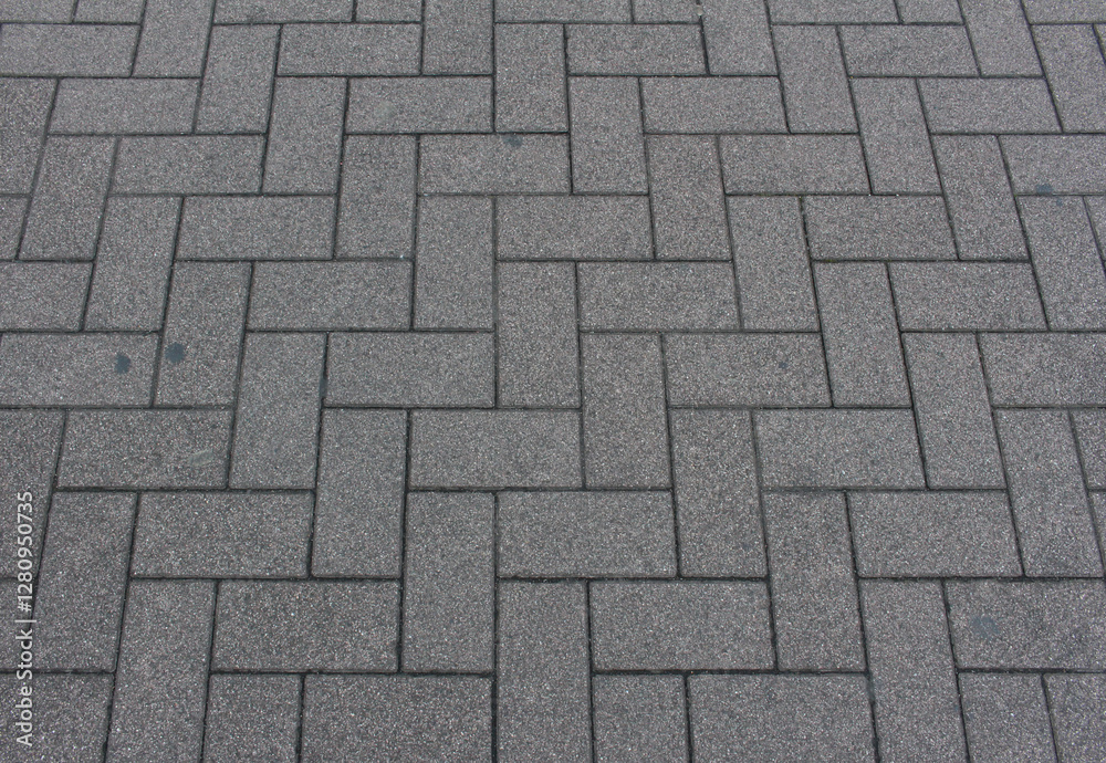 Texture of square paving tile. Pattern of gray sidewalk tiles in the street. Concrete pavers close up background. Texture of square paving tile. Pattern of gray sidewalk tiles in the street. Concrete pavers close up background.