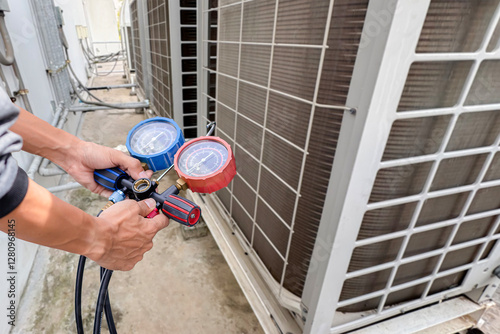 Air conditioner technician checking air conditioner operation	