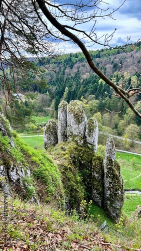 Vertical photo of Rekawica Rock in Ojcow National Park, shaped like a human hand. Ideal for travel, hiking, and active lifestyle themes, showcasing natural beauty, adventure, and outdoor exploration.