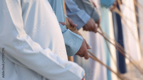 Traditional Emirati Al Ayala male dance, cultural UAE heritage, hands in frame
