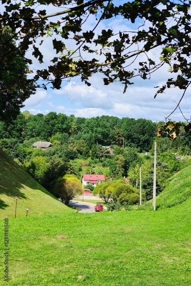 Fototapeta premium Cityscape, view between two hills on city houses and green spaces.