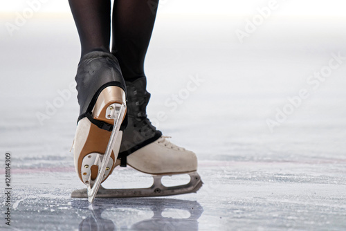 Billede på lærred Figure skaters skates while sliding on ice - professional figure skating