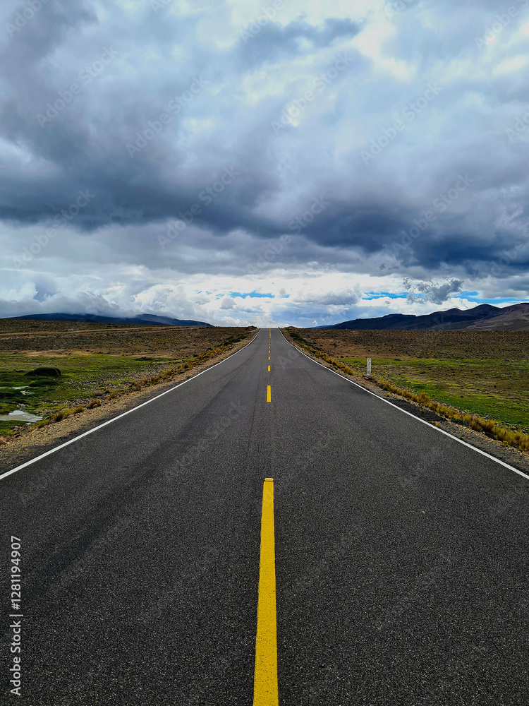 Naklejka premium Endless straight road through the Andes mountains under a dramatic sky, Peru.