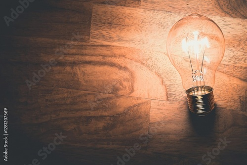 The concept of electricity is highlighted by a vintage glowing light bulb on a black background, embodying an illuminated retro style light bulb and creative idea