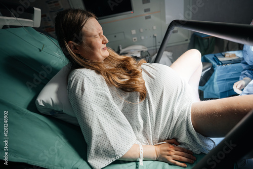 Woman in Active Labor Pushing During Childbirth in Hospital