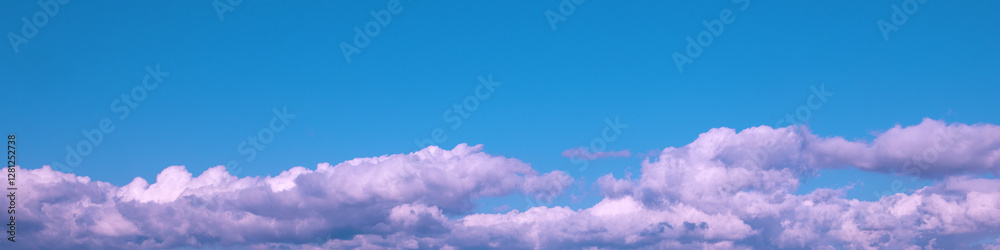 Fototapeta premium 4x1 banner - a band of white cumulus clouds in a blue sky
