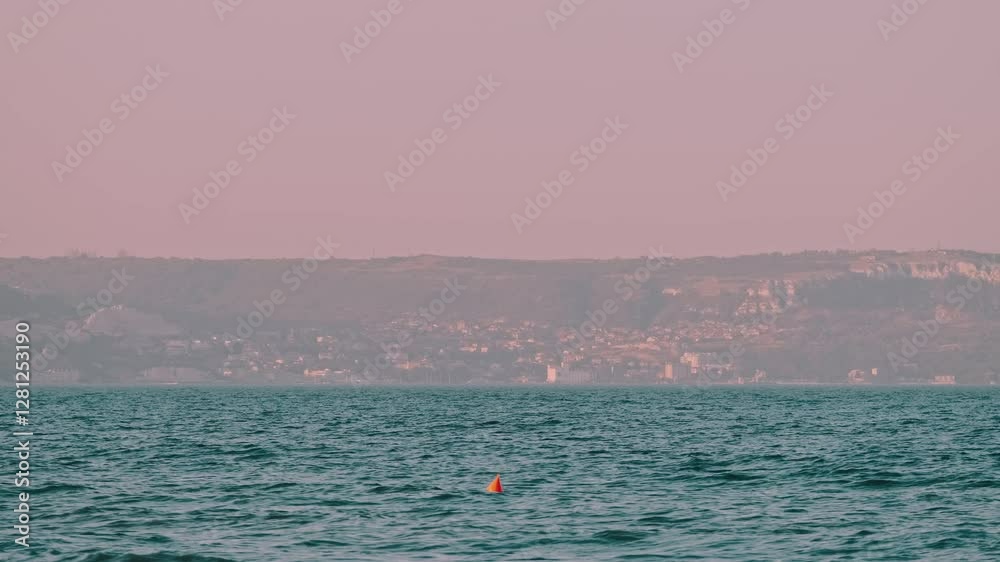 A skilled swimmer glides through the ocean at dusk, showcasing natures beauty and profound calmness A skilled swimmer glides through the ocean at dusk, showcasing natures beauty and profound calmness