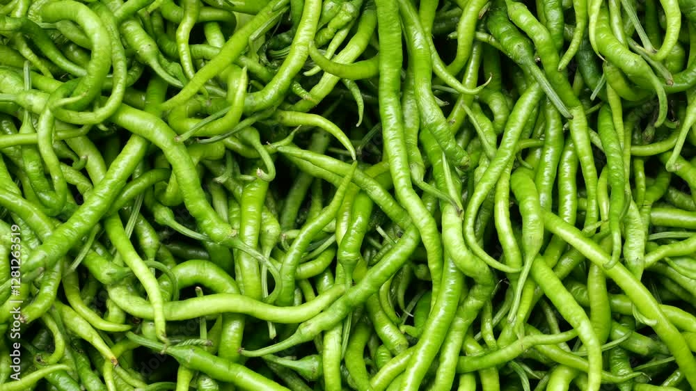 Fresh green chilies displayed at a vibrant market stall Fresh green chilies displayed at a vibrant market stall