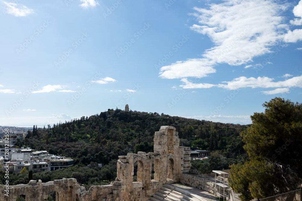 Panoramic view of the Acropolis and the top of the walls of the ancient odeon of Herodes Atticus in Athens Panoramic view of the Acropolis and the top of the walls of the ancient odeon of Herodes Atticus in Athens