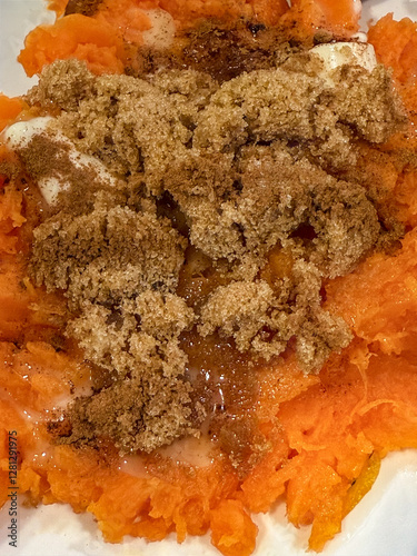 Closeup Of Smashed Sweet Potato Topped With Butter And Brown Sugar