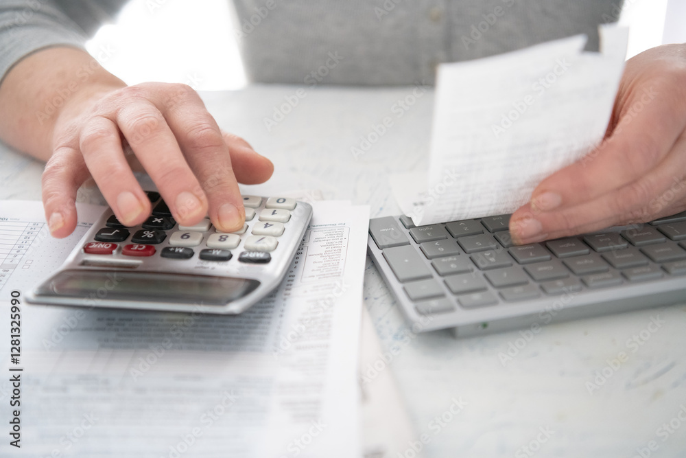 Close up of woman's hands using calculator to do financial calculations. Close up of woman's hands using calculator to do financial calculations.