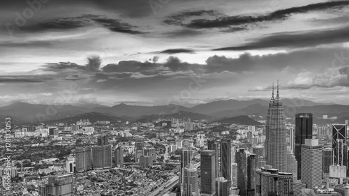 Canvas Print Dramatic aerial view of Kuala Lumpur skyline on a cloudy day with misty skyscrap