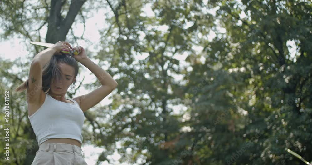Young woman playing pickle ball in a park with friends on a sunny summer day. They are active, having fun, enjoying their time together and bonding over their favorite sport. Young woman playing pickle ball in a park with friends on a sunny summer day. They are active, having fun, enjoying their time together and bonding over their favorite sport.