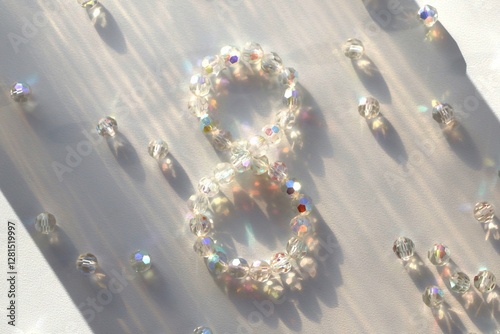 Stylish shiny postcard for Women's Day March 8, eight of transparent iridescent beads on a white background. Celebration of International Women's Day. Concept March 8.