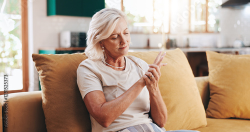 Senior woman, hand pain and arthritis in home, orthopedic joint inflammation and check wrist damage. Muscle, carpal tunnel and elderly person with injury accident, rheumatoid and poor circulation